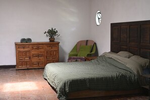 A bedroom with a bed, a wooden dresser, a chair, and a potted plant. - Mansion with a private garden in downtown Tepoztlán (pet-friendly) (Tepoztlán)