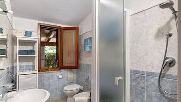 Ein Badezimmer mit Dusche, Toilette und Waschbecken.