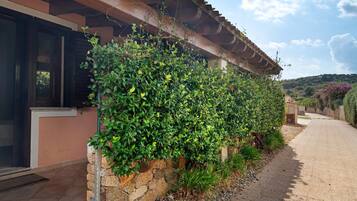 A building with a stone wall and a metal railing.