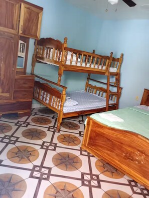 A room with a bunk bed, a wooden wardrobe, and a patterned floor. - JB King Ranch Beach House (La Libertad)