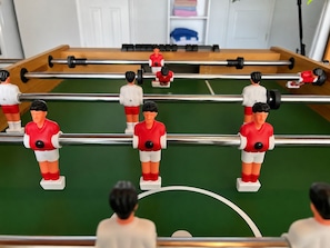 A foosball table with players in red and white uniforms. - Clearwater Oasis | Private Pool | 5mi from Beach (Pinellas County)