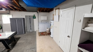 A laundry room with a washing machine, dryer, and cabinets. - Clearwater Oasis | Private Pool | 5mi from Beach (Pinellas County)