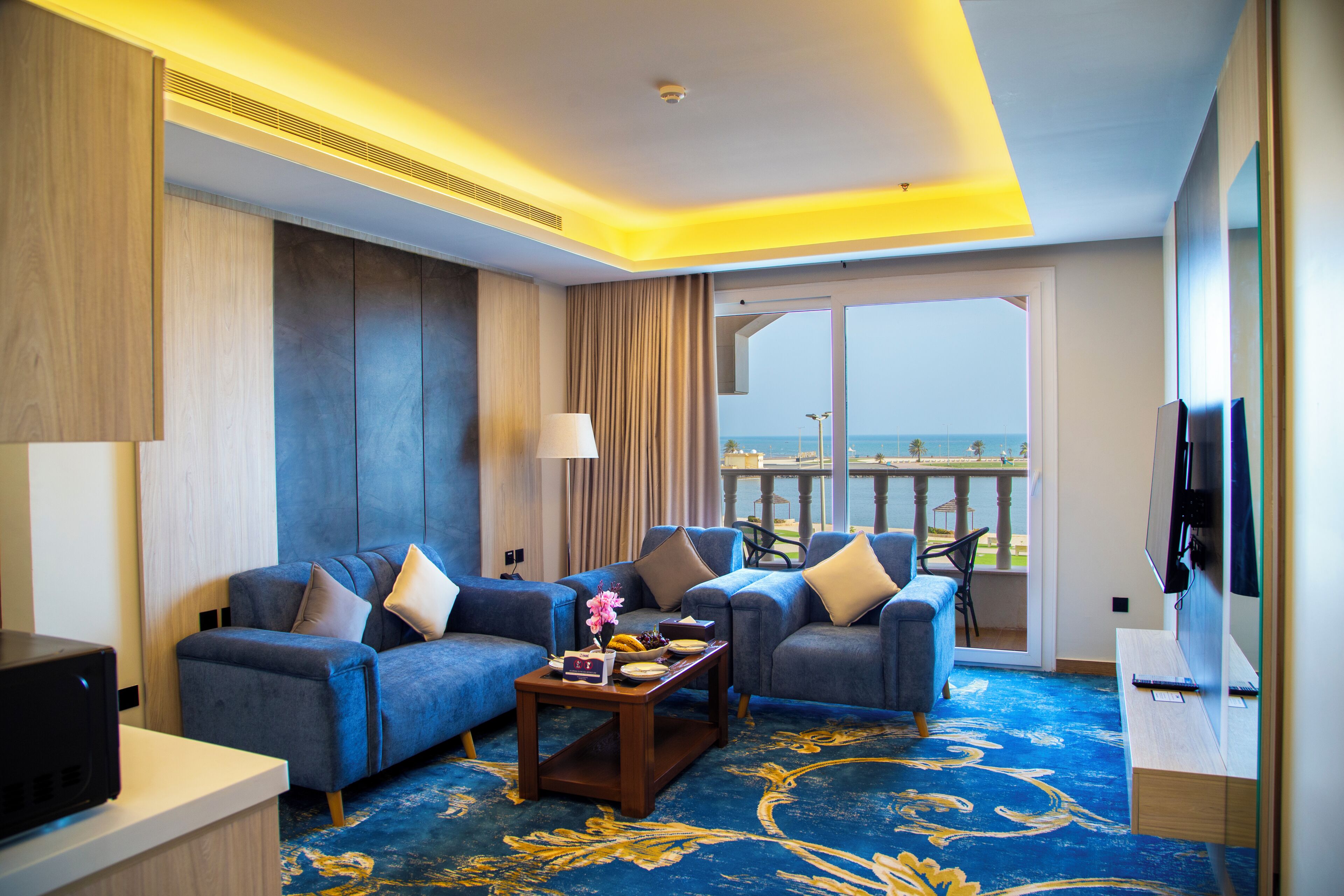 Suite Deluxe, vista a la playa | Área de sala de estar