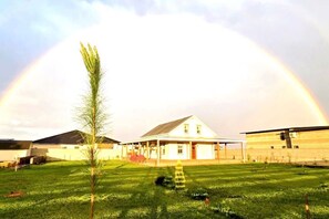 A house with a porch and a grassy yard.
