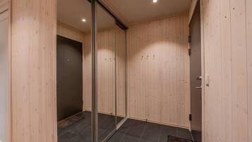 A room with wooden panel walls, a sliding glass door, and a tiled floor.