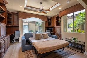 A bedroom with a bed, a desk, a chair, and a TV. - Fairway Peaks at PGA West | Mountain & Golf Views (La Quinta)