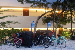 Bicycles parked in front of a building with a covered area, possibly a bike rental service. - Brand-New Studio with 4 Pool Access at The Leaf Playacar, | All-Inclusive (Playa del Carmen)