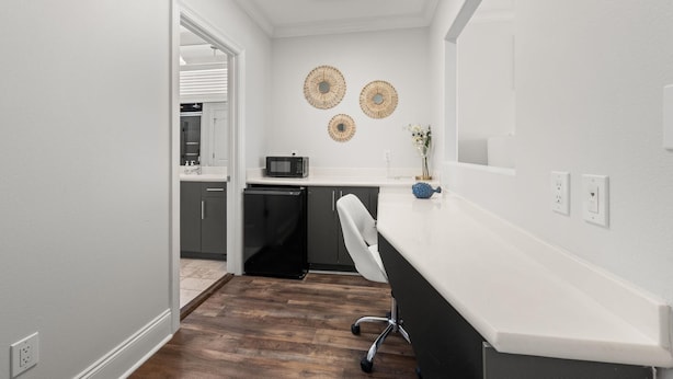 A modern kitchen with a microwave, a small refrigerator, and a white countertop. - The Hammock Dunes Collection (Orange Beach)