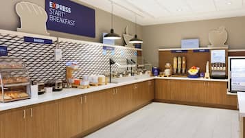 A breakfast area with a sign for Express Start Breakfast, a bakery section, and a self-serve station with hot food options.