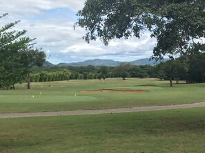 A golf course with a clear sky, trees, and distant mountains. - Beautiful house with private pool Hacienda Pinilla (Hacienda Pinilla)