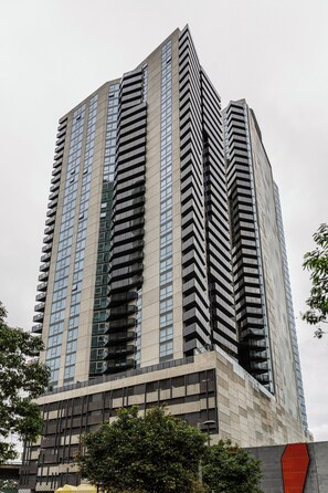 A high-rise building with a modern architectural design, featuring a prominent vertical structure and multiple balconies. - Marco Panoramic Skyline Escape with Pool and Gym (Southbank)