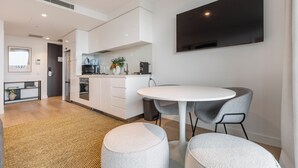 A modern kitchen with white cabinetry, a built-in oven, and a coffee machine. - Marco Panoramic Skyline Escape with Pool and Gym (Southbank)