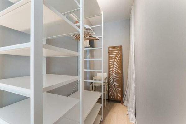 A spiral staircase with white railings leading to a landing. - A stunning, elegant, and bright apartment, ideally located in the heart of the city. (Oostende)