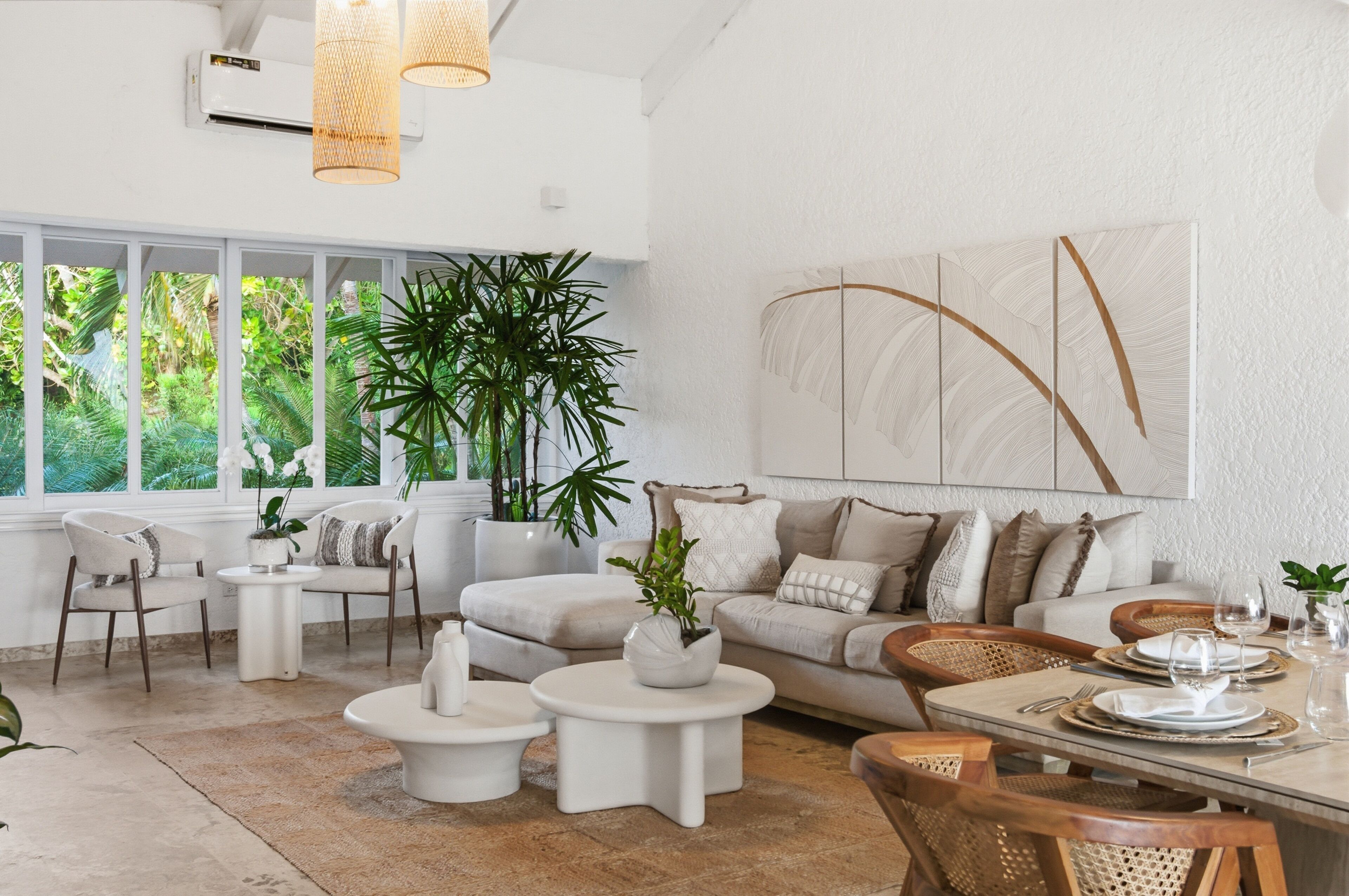A modern living room with a large window, a sofa set, a dining table, and decorative plants.