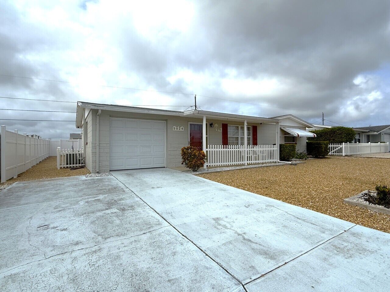A single-story house with a garage, a front porch, and a driveway.