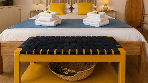 A double bed with a wooden headboard, two bedside lamps, and a round mirror on the wall. - Vrbo Property (Bacoli)