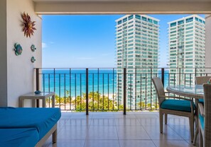 A balcony with a view of the ocean and tall buildings. - Grand Venetian Oceanfront by Monyxbnb (Puerto Vallarta)