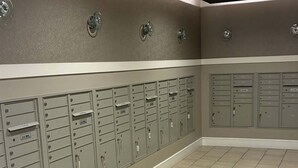 A row of U.S. Mail lockers with a tiled floor and recessed lighting. - Preston Royal Double II I Premium 2BR in Dallas (Dallas)