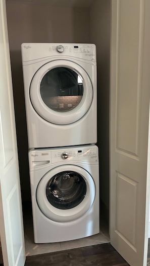 A compact laundry room with two stacked Whirlpool front-loading washing machines. - Preston Royal Single I Premium 1BR in Dallas (Dallas)