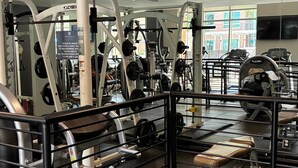 A gym with various exercise equipment, including weight machines and benches. - Preston Douglas Double I Premium 2BR in Dallas (Dallas)