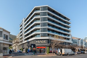 A multi-story building with a modern design, featuring balconies and a prominent signage for 'The Sage.' - The Sage Coastal Comfort Convenience (Cape Town)