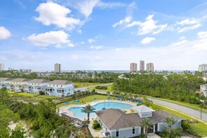A residential area with a swimming pool, multiple-story buildings, and a clear view of the ocean. - Over the Dunes at Lost Key Villas (Pensacola)