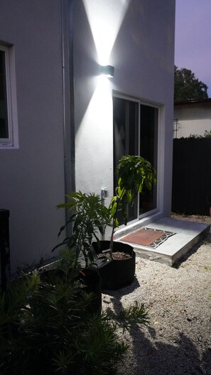 A house with a door, a window, and a potted plant in the foreground. - Private Boho Tiny Home and Retreat with Monthly Stay + Parking (Miami)