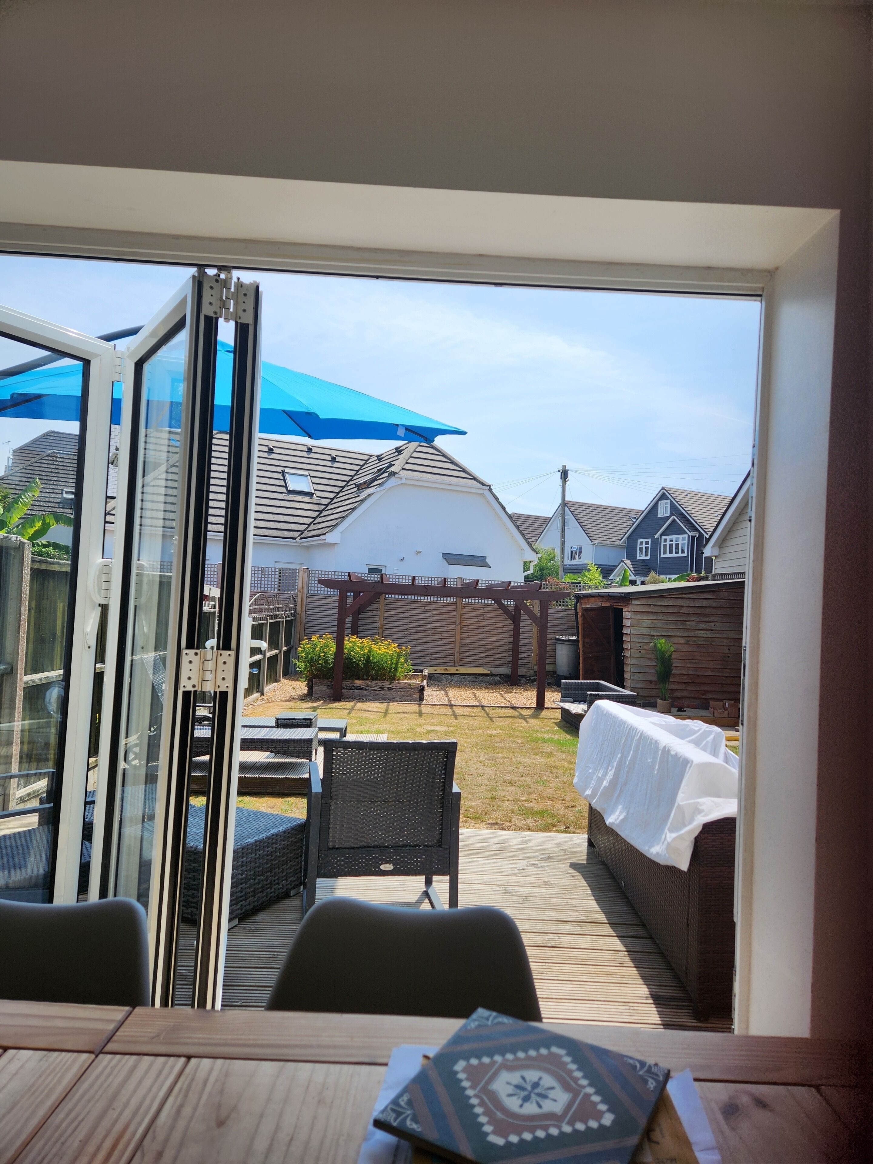A patio area with a table, chairs, and a covered seating area.