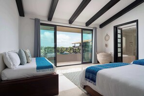 A hotel room with a balcony, two beds, a large woven basket, and a dreamcatcher on the wall. - Ocean & Golf View Penthouse | Private Chef & Cart (Punta de Mita)