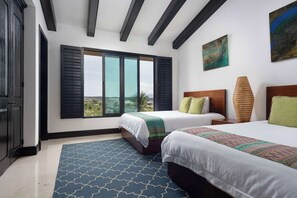 A hotel room with two beds, a large window with shutters, a painting on the wall, and a patterned rug. - Ocean & Golf View Penthouse | Private Chef & Cart (Punta de Mita)