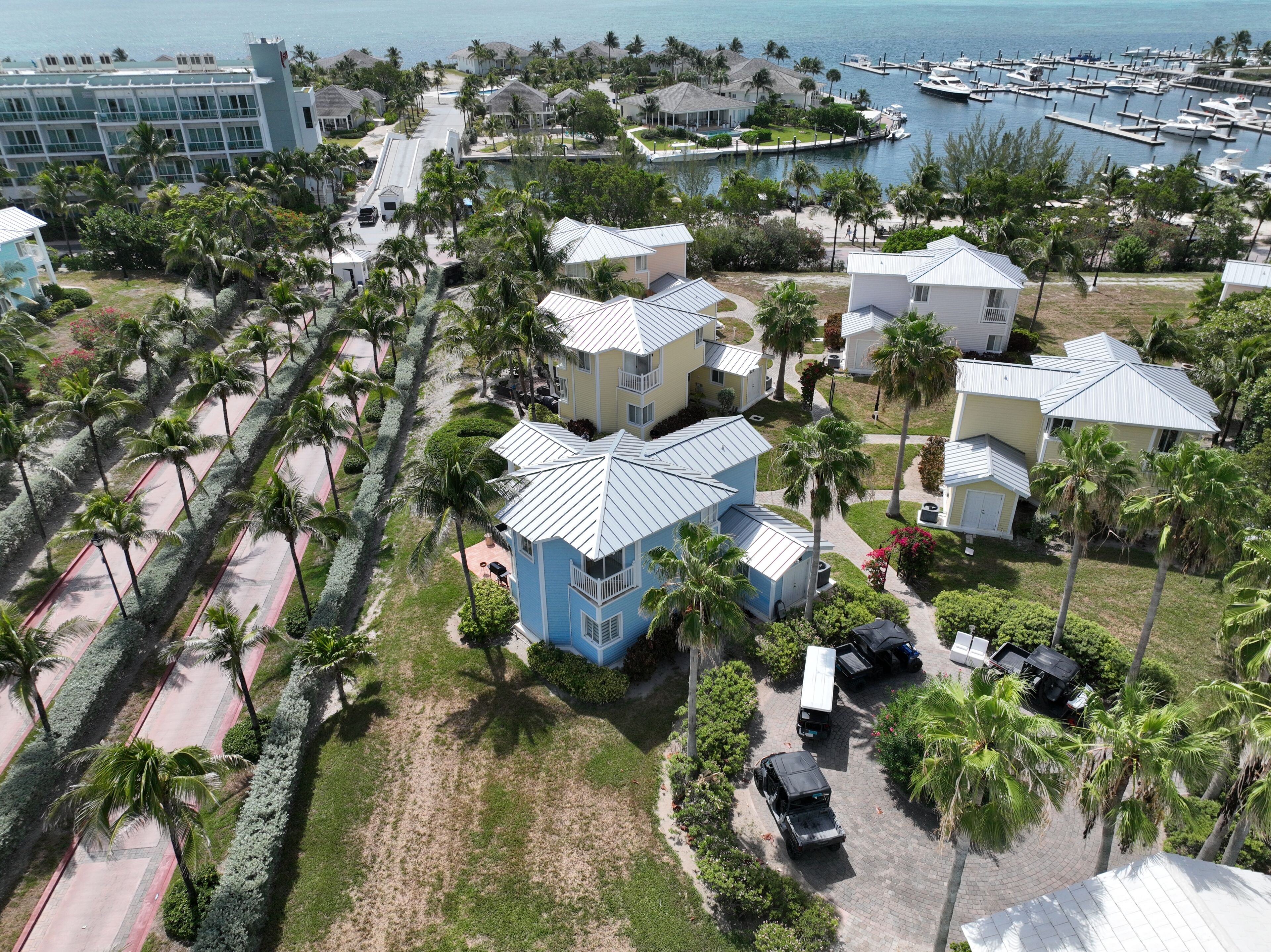 A resort with multiple buildings, a marina, and a beach area.