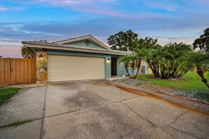 A single-story house with a garage, a stone facade, and a number '9681' on the garage door.