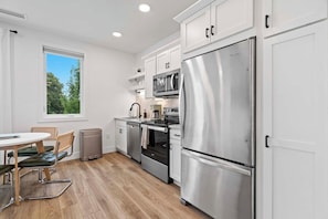 Coffee/tea maker, fridge, microwave, oven - West Bay Views | Dog Friendly + Near Downtown TC (Traverse City)