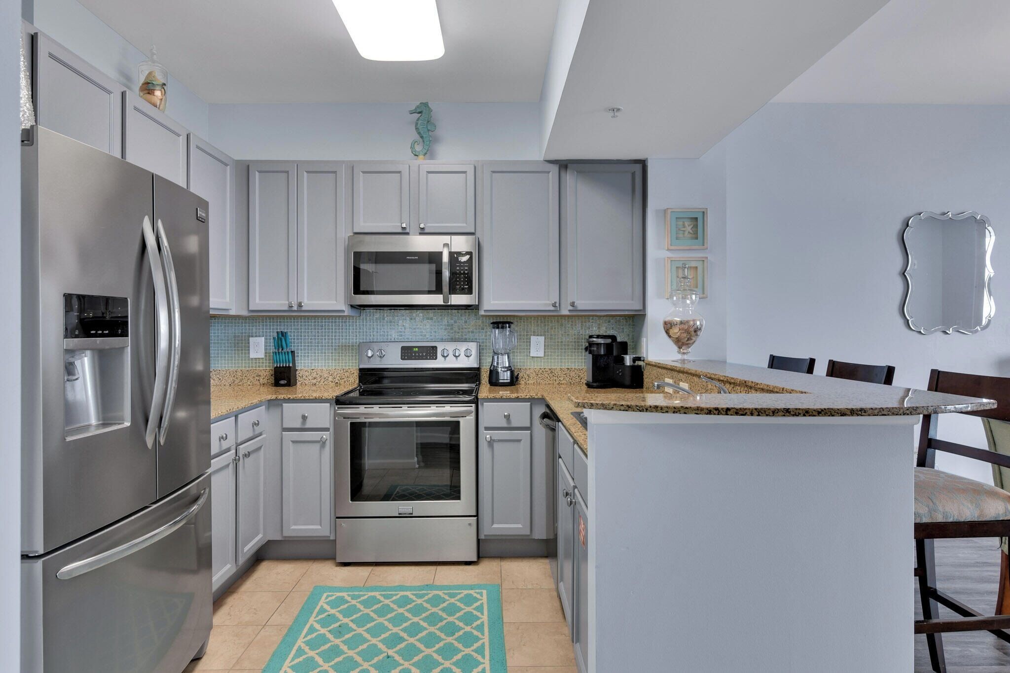 A modern kitchen with stainless steel appliances, a microwave, and a stove.