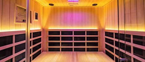 A sauna with wooden walls and a bench.
