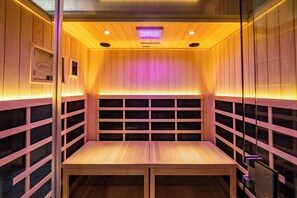 A sauna with wooden walls and a bench. - Theater! Sauna! Jacuzzi! Firepit! EV Charger (Cosby)