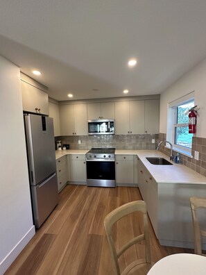 A modern kitchen with stainless steel appliances, a microwave, and a built-in oven.