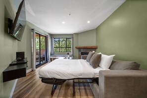 A bedroom with a bed, a desk, and a fireplace. - Whistler Central |Free PKG&Hot Tub,Walk2Everything (Whistler)