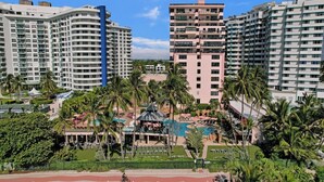 A resort with multiple high-rise buildings, a swimming pool, and palm trees. - Ocean View Condo in Beachfront Resort Beach, Pool, Gym 607 (Miami)