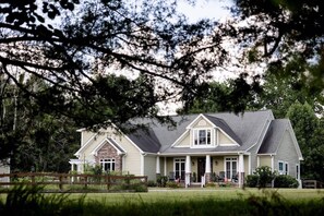 A two-story house with a front porch, a covered entryway, and a fenced yard. - Cedar Peak - Pool, Hot Tub & Gym, Sleeps 24 (Cheatham County)