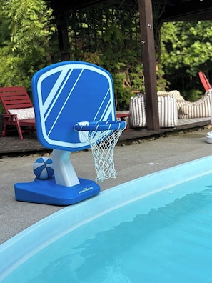 A poolside basketball hoop with a blue backboard and net, positioned near a swimming pool. - Cedar Peak - Pool, Hot Tub & Gym, Sleeps 24 (Cheatham County)