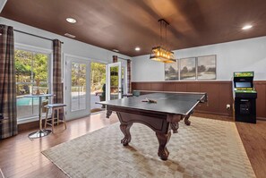 A billiards table in a room with a view of a pool outside. - Cedar Peak - Hot Tub, Sauna, Theater, Sleeps 24 (Cheatham County)