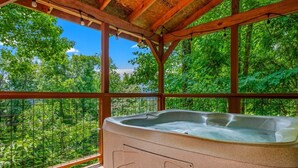 A hot tub under a wooden pergola with a view of a forest. - Ember Hollow | Hot Tub • Near Gatlinburg • Pets (Gatlinburg)