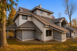 A modern two-story house with a sloped roof, a covered porch, and a visible address sign. - 7 minutes from the Killington Base Lodge and seconds away from the best restaurants and nightlife! (Killington)