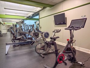 A gym with stationary bikes, a treadmill, and a television on the wall. - 7 minutes from the Killington Base Lodge and seconds away from the best restaurants and nightlife! (Killington)