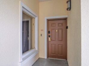 A brown door with a window to the left, a doorbell, and a mailbox. - A Relaxing Getaway & More! M452 (Orlando)
