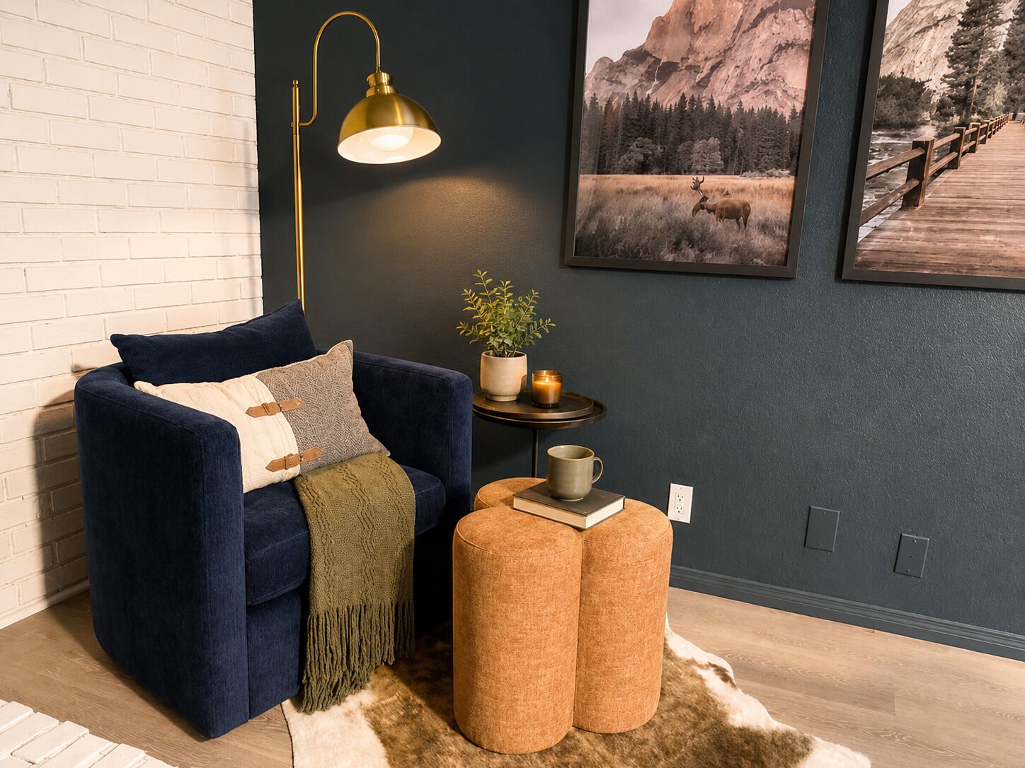 A cozy room with a blue sofa, a small round table with a plant, a candle, and a book.