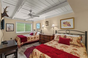 A bedroom with two beds, a ceiling fan, a window with blinds, and artwork on the walls. - Sun Valley Atelier Retreat - 5 minute walk to Sun Valley Pavilion (Sun Valley)