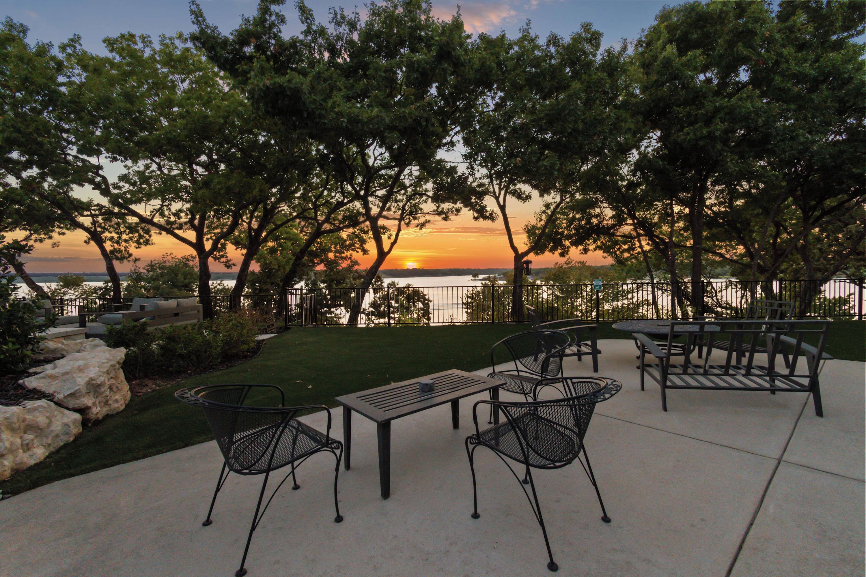Spacious patio with stunning lake and sunset views.