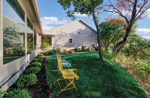 A residential property with a well-maintained lawn, a metal chair, and a decorative sculpture. - 4-BD/2-BA Southern Retreat with Waterfront Patio (Gainesville)